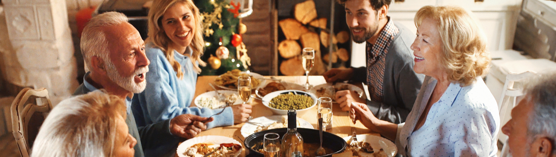 family around dinner table at christmas